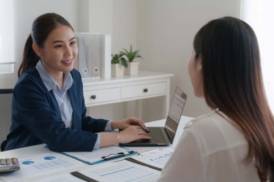 Woman at laptop having a conversation