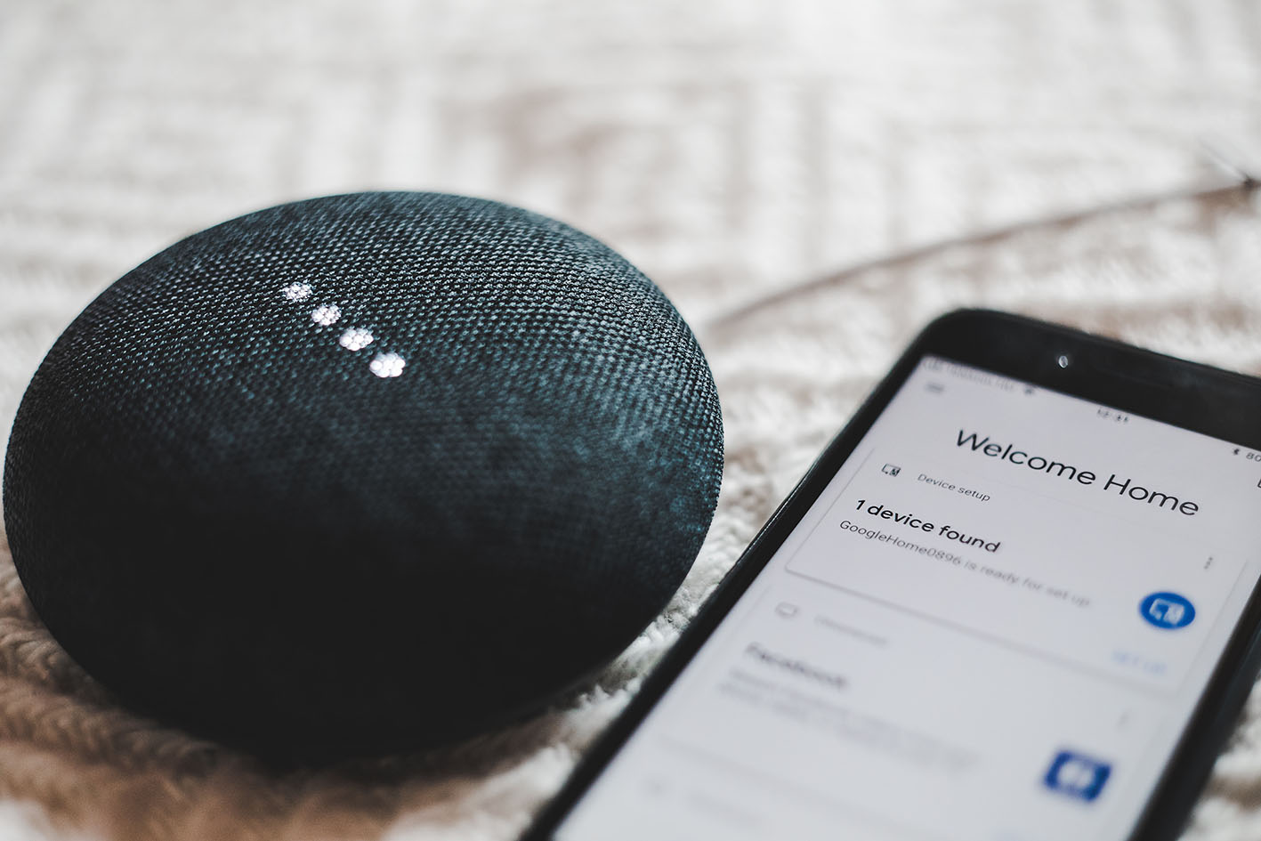 Smart bluetooth speaker next to touch screen phone