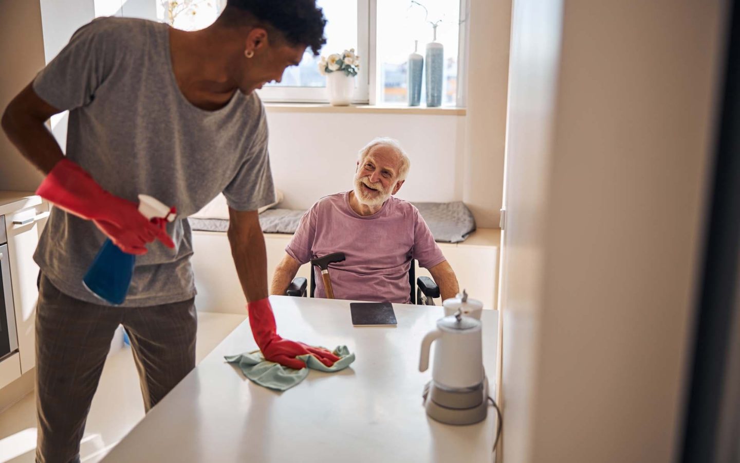 Elderly man smiling at a volunteer