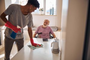 Elderly man smiling at a volunteer