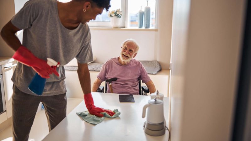 Elderly man smiling at a volunteer